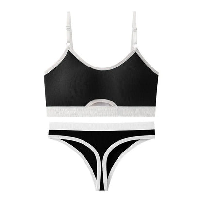 White underwired sports bra set with contrast dark grey back detailing and matching briefs on a mannequin.