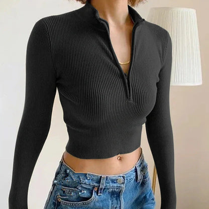Women's black zip-front crop top with slim fit and long sleeves on hanger