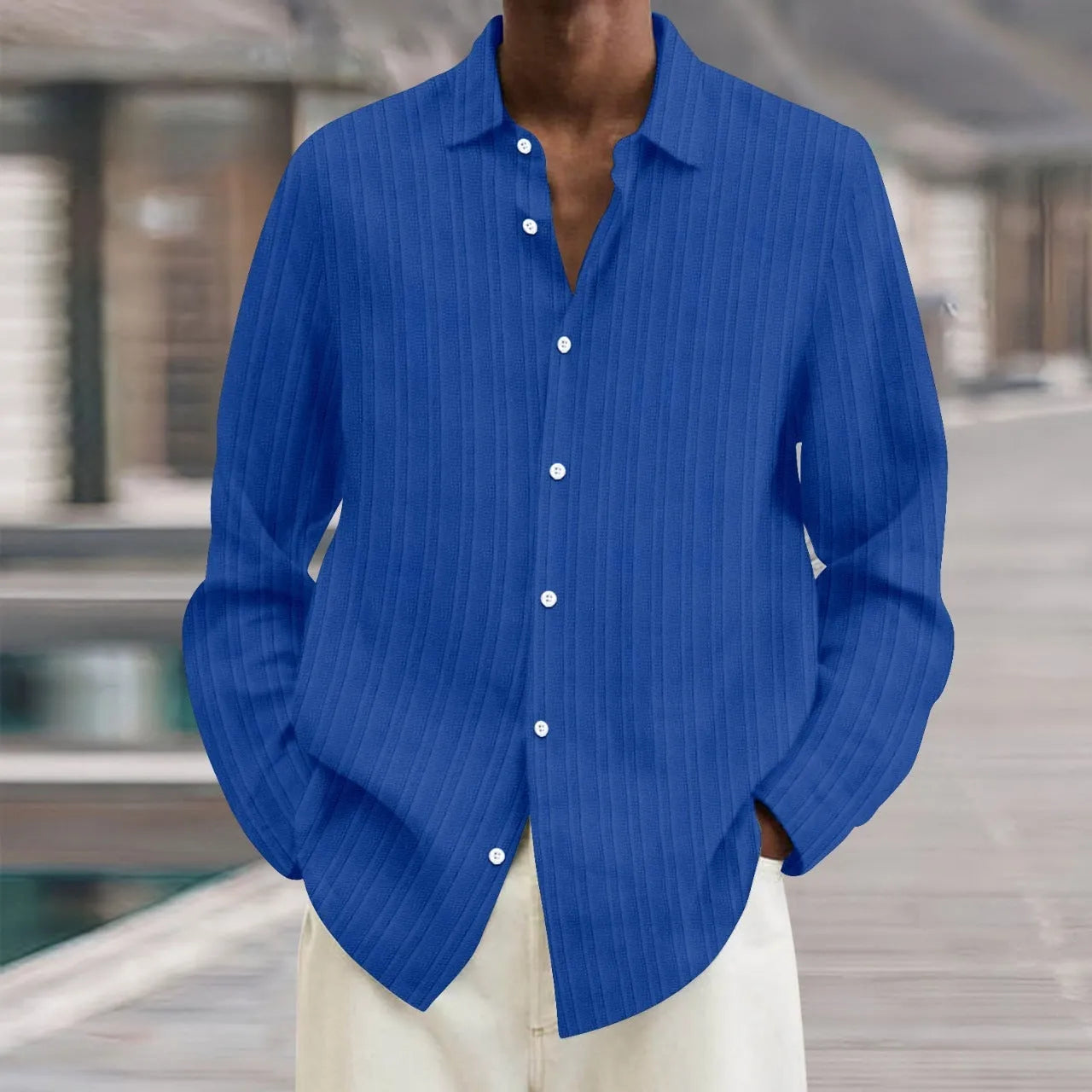 Man wearing a loose fit plain colour striped long sleeve cardigan shirt.