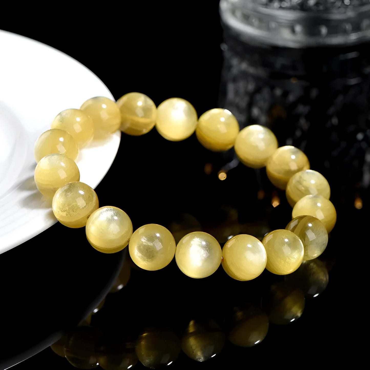 Yellow golden dragon mica round beads bracelet with polished geometric beads on a string.