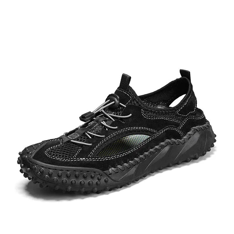 Men's black waterproof wading sandals with elastic band and perforated leather mesh upper on a rubber sole.