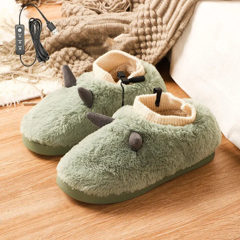 USB heating slippers in black plugged into a laptop, showing the cable and soft velvet upper.