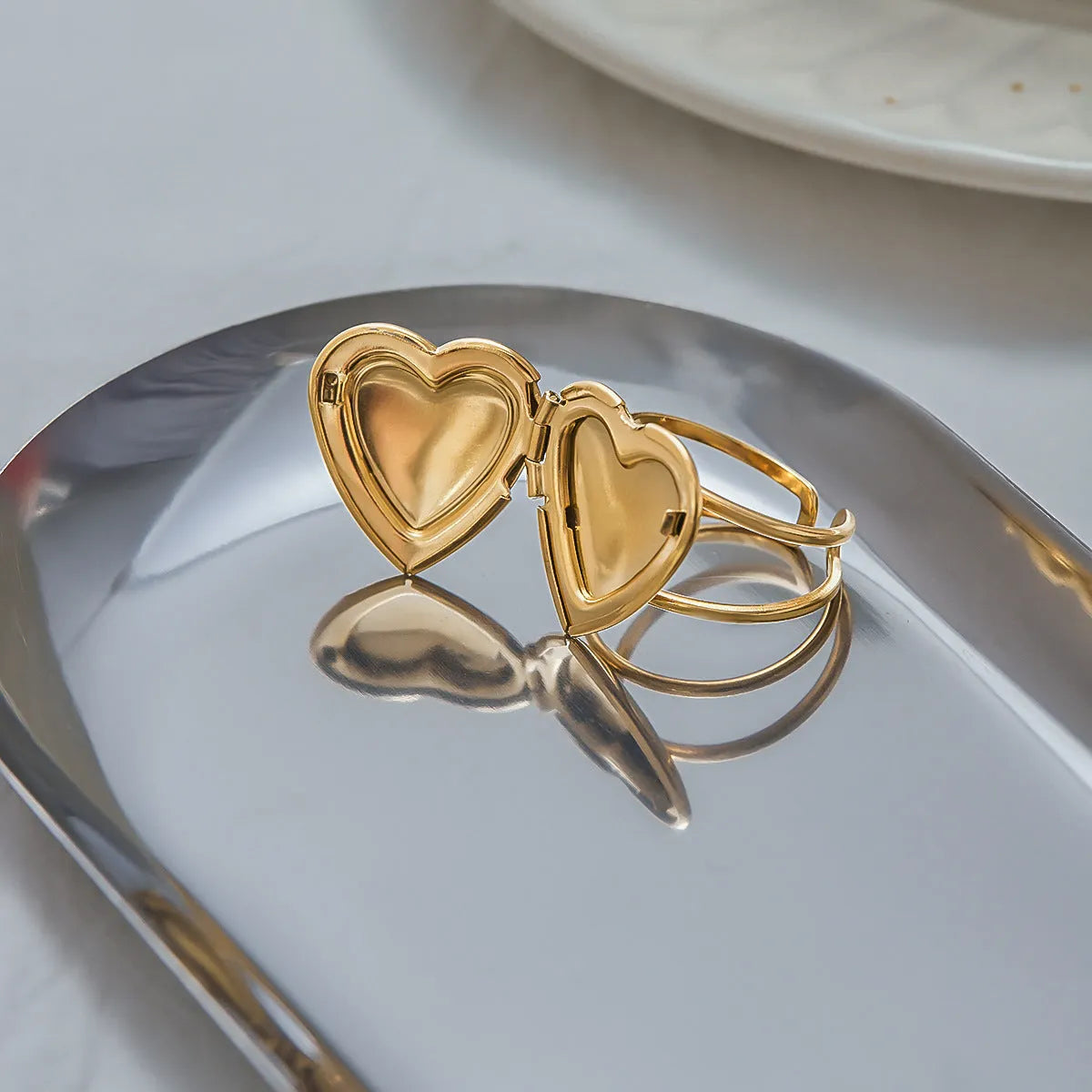 Stainless steel love heart-shaped ring for women with electroplated finish, shown as a single ring