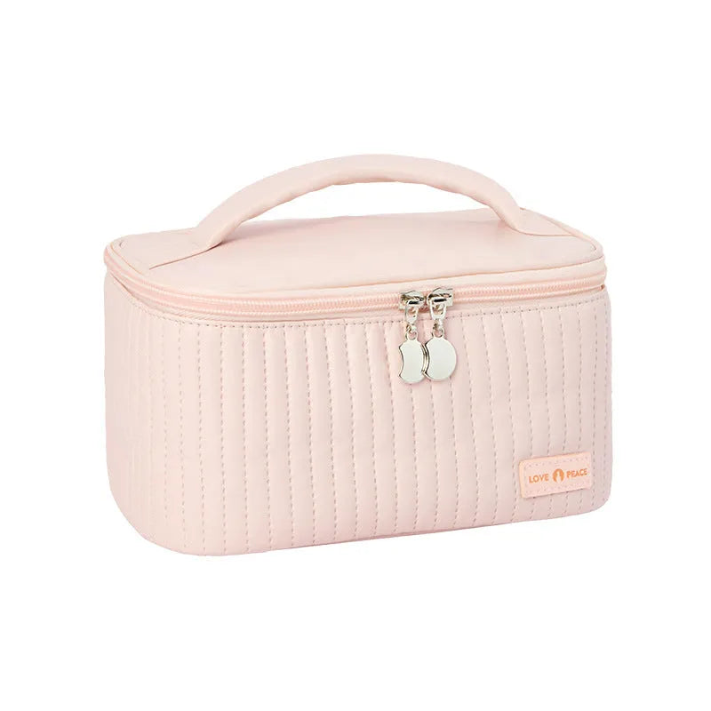 Open-top pastel pink PU leather makeup bag with a flat base, showing interior space.