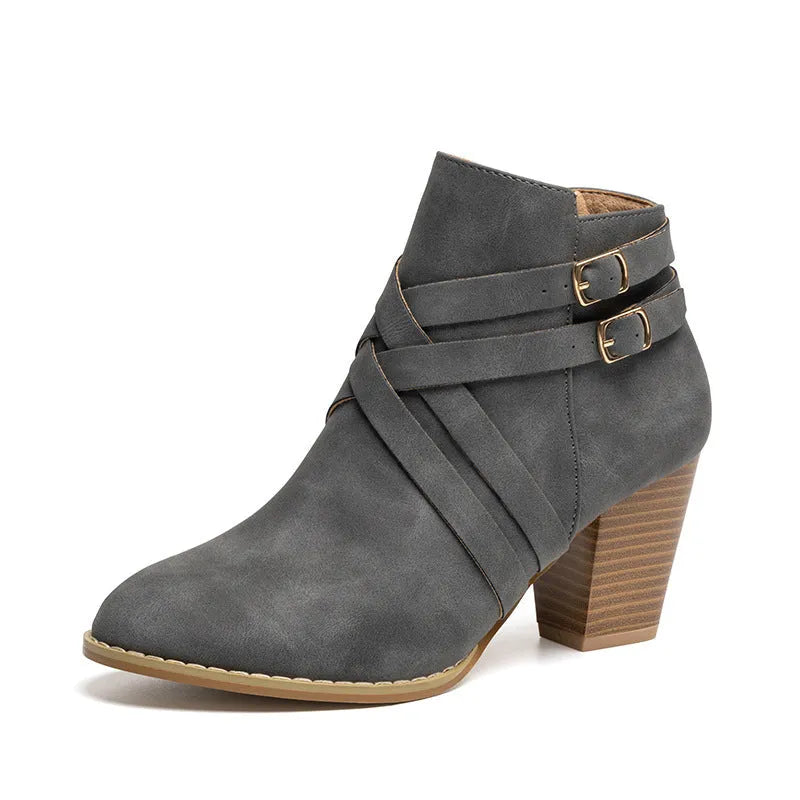 Women's short ankle boots with a belt buckle and side zip in black, brown, or grey with a 7cm heel.