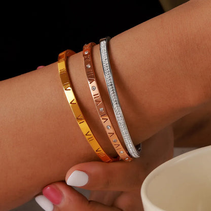 Titanium steel Roman numeral bracelet with gold plated carved design and diamond-embedded detail