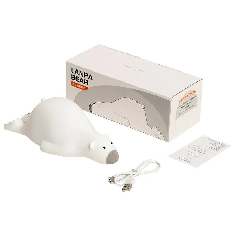 White bear-shaped silicone night light on a table with USB cable.