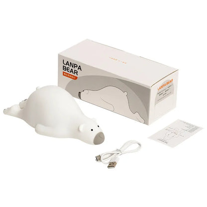 White bear-shaped silicone night light on a table with USB cable.