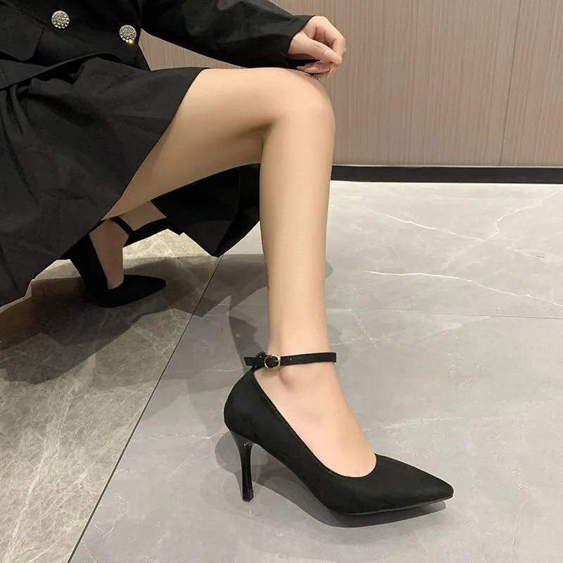 Women's black stiletto heel pumps with skull pattern and buckle detail, showing 8cm heel height