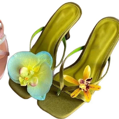Women's handmade asymmetric flower high heel sandals in black, green, pink, or white on a calf leather upper with EVA sole.