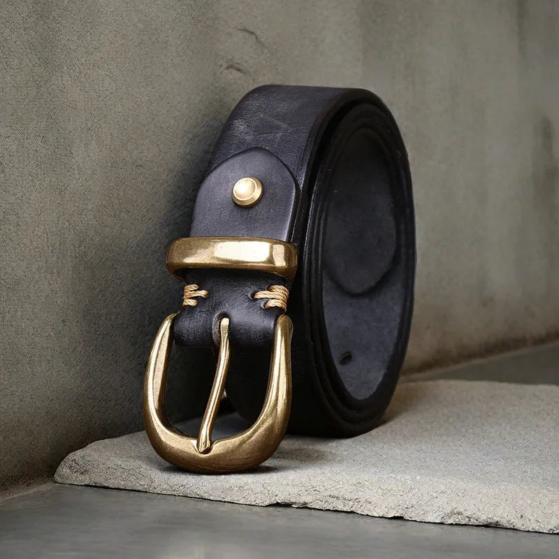 Men's black cattlehide leather jeans belt with a copper pin buckle shown on a flat surface.