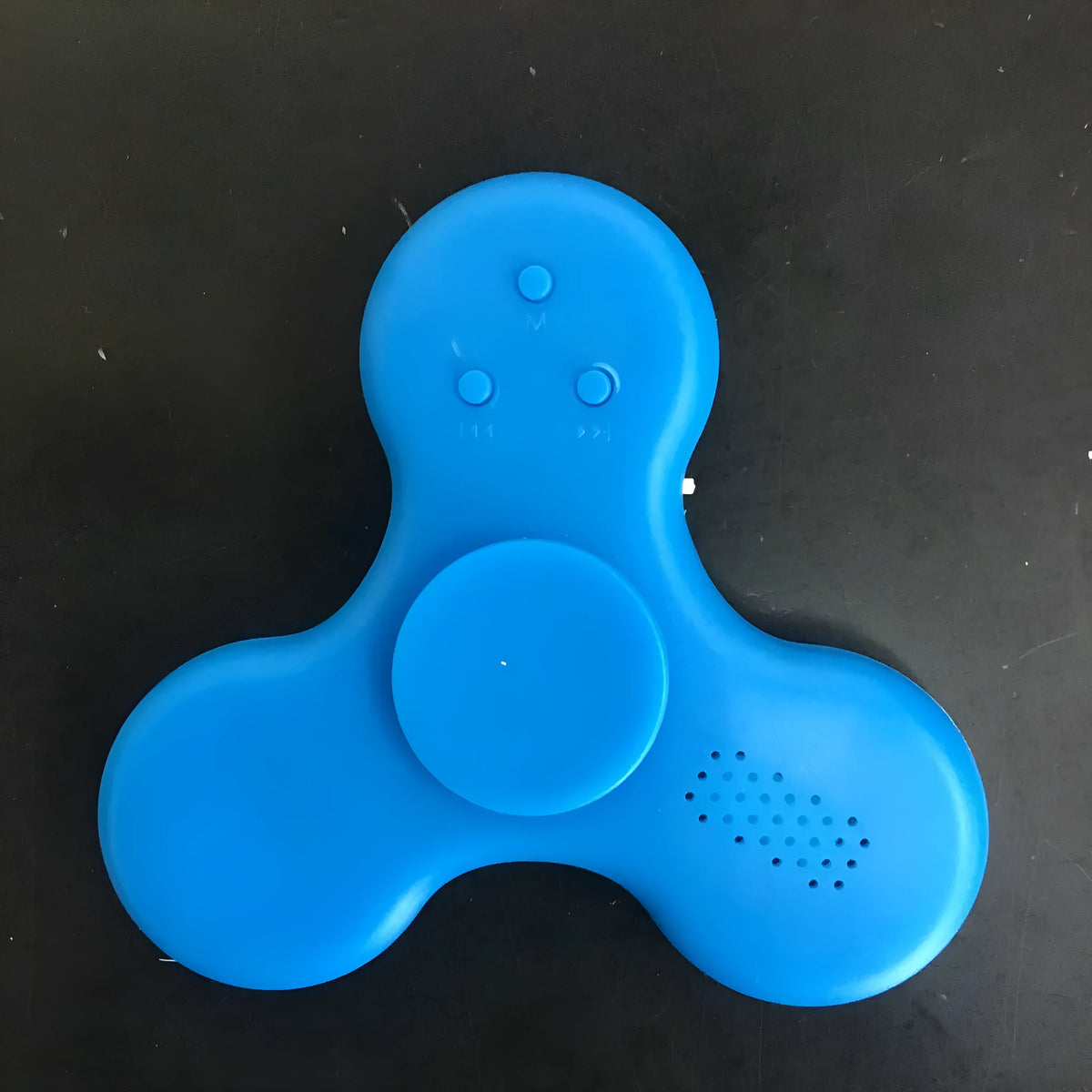Square Bluetooth speaker music fidget spinner MP3 player in blue, showing button controls and compact design.