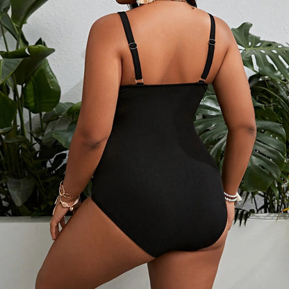Black plus size one-piece swimsuit for women on a hanger.