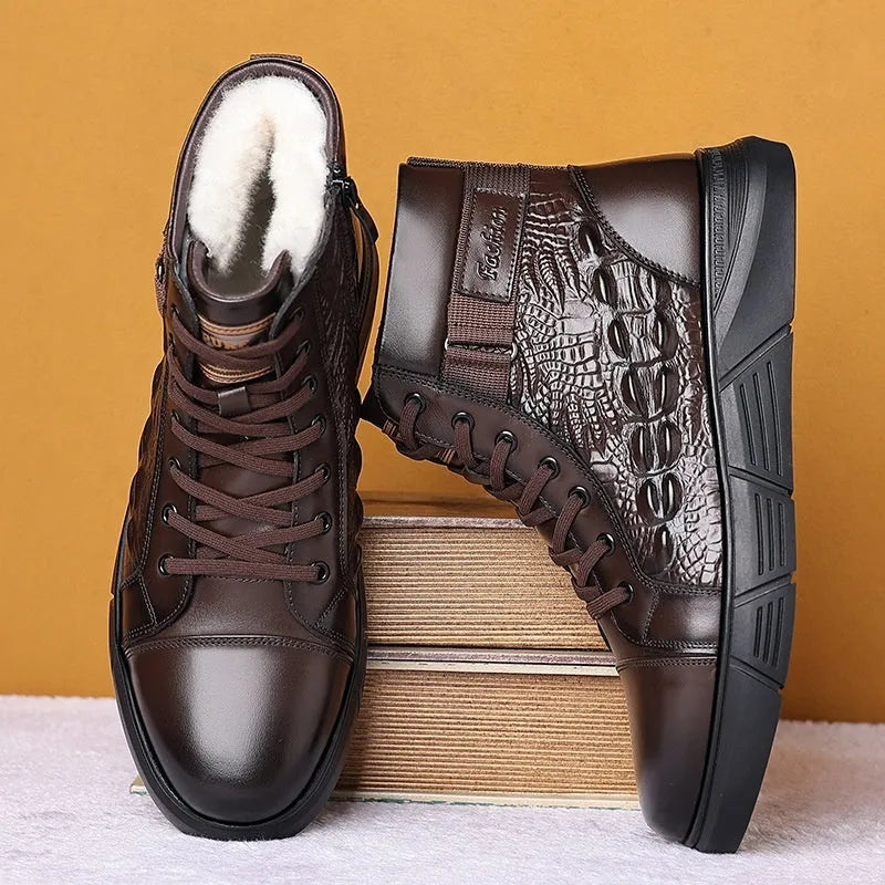 Men's brown genuine leather lace-up snow boots with fur lining and deep-tread rubber sole on a wooden surface.