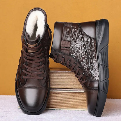 Men's brown genuine leather lace-up snow boots with fur lining and deep-tread rubber sole on a wooden surface.