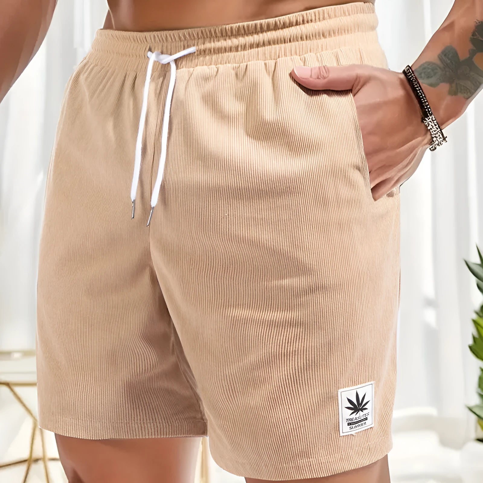 Men's straight-cut drawstring shorts in blue, shown on a model for summer casual wear.