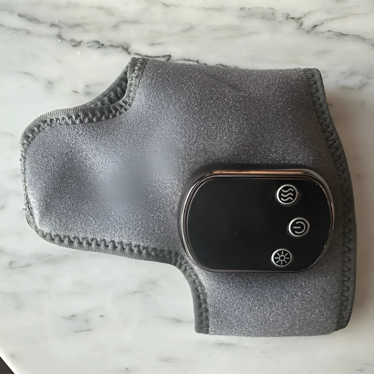 Grey USB electric heating ankle wrap with timer and computer control, shown as a joint massage unit
