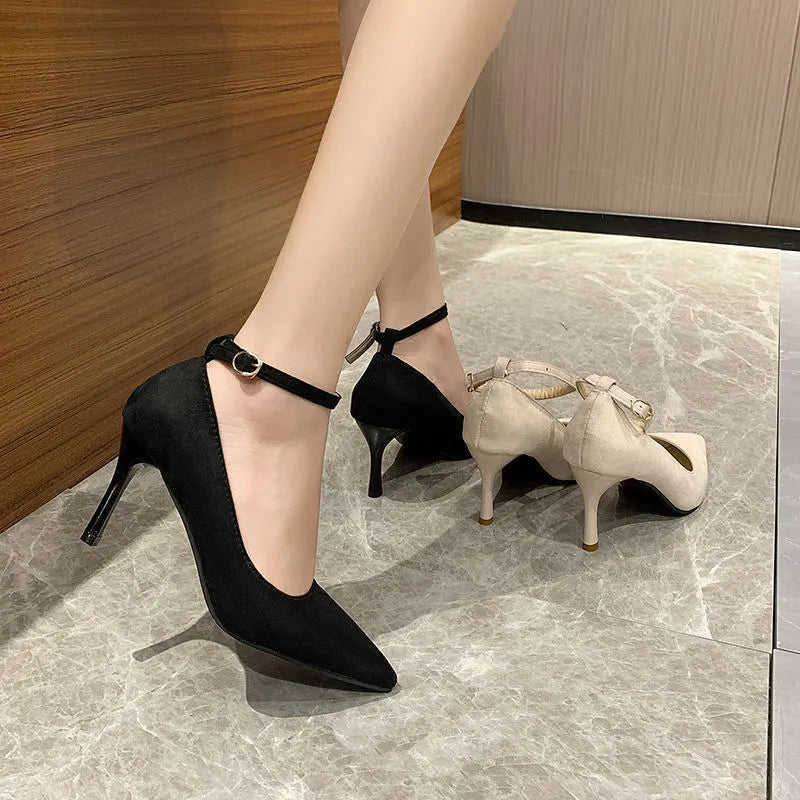Women's black stiletto heel pumps with skull pattern and buckle detail, showing 8cm heel height
