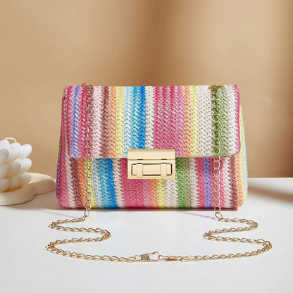 Women's small square straw cross-body bag with lock closure, shown in rainbow colour.