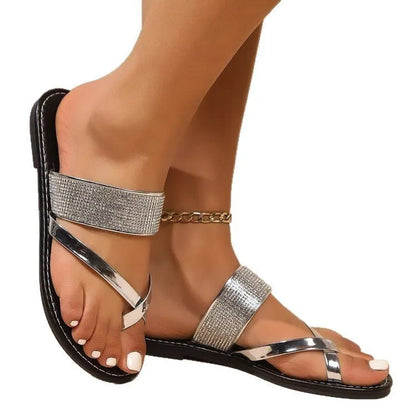 Women's flat beach sandals with rhinestone toe strap in black, gold or silver colours