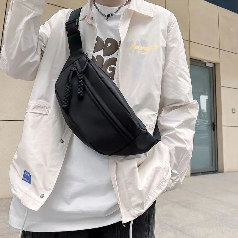 Men's small black polyester crossbody chest bag with adjustable strap.