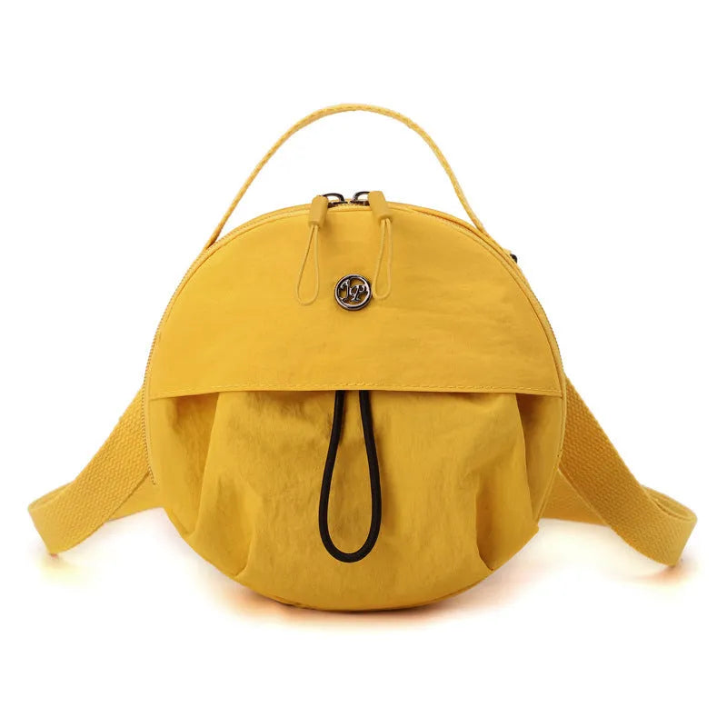 Out shoulder crossbody messenger bag in nylon showing interior zipped changing bag, phone pocket, and document compartment.