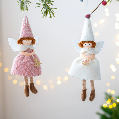 White and pink cloth felt Christmas angel skirt pendant ornament on a tree branch.