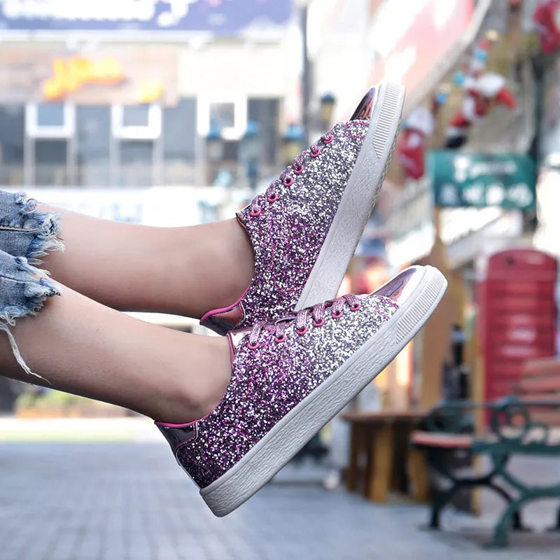 Women's low-top casual shoes with black sequin upper, round toe, and white rubber sole with lace-up closure.