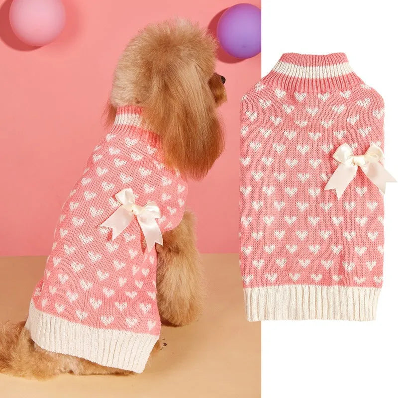 Dog wearing red love heart design sweater with bow decoration