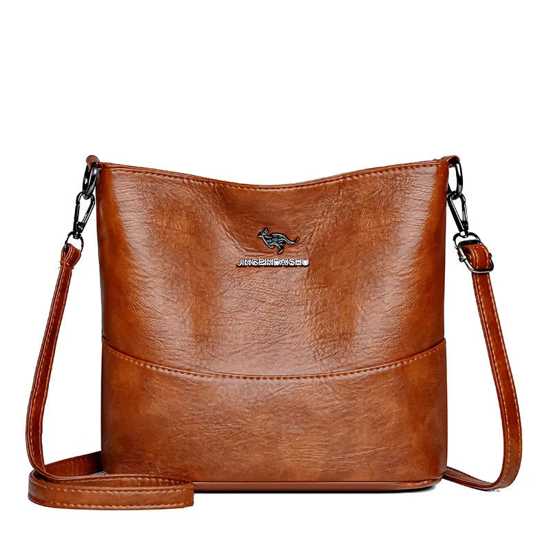 Women's soft leather bucket shoulder bag in black, wine red, or ginger yellow with large capacity and minimalist design