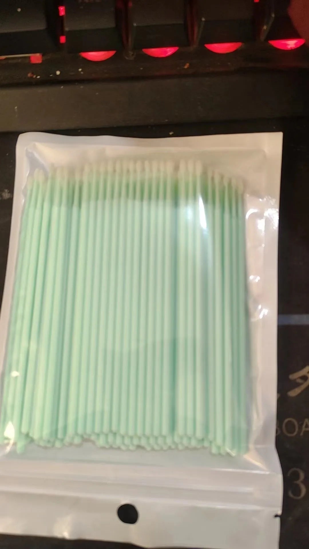 Disposable micro applicator brushes with coloured plastic handles and bendable cotton swab tips