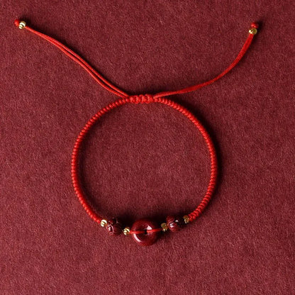Cinnabar heart-shaped bracelet with safety buckle closure and adjustable coloured rope in traditional Chinese design
