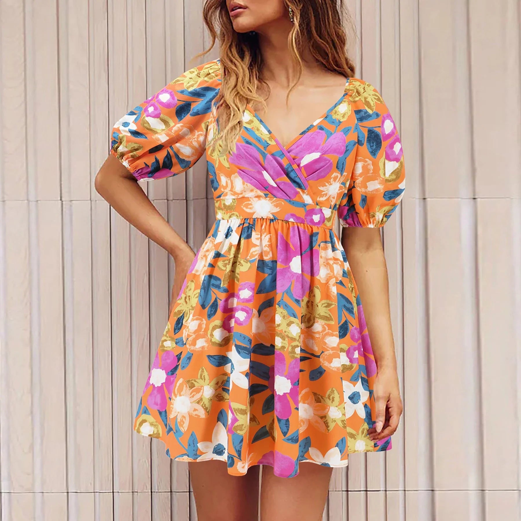 Stylish floral mini dress with V-neck and lantern sleeves, perfect for summer vacations and beach outings