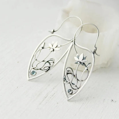 Silver lotus vine design women's earrings with geometric rhinestone details on electroplated alloy