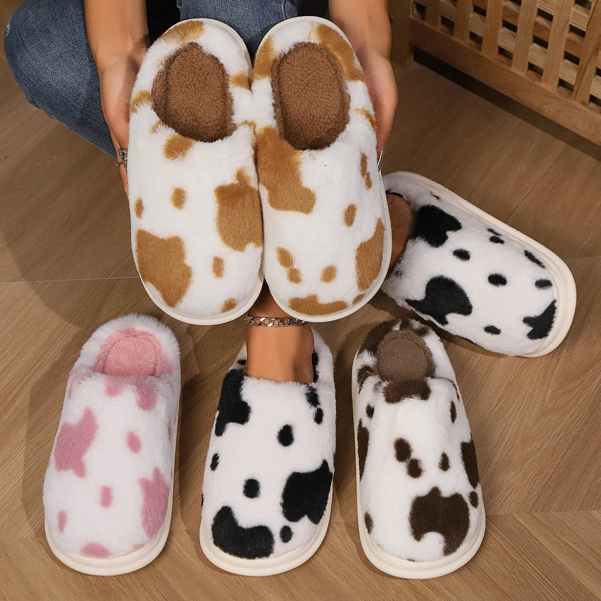 Cozy cow print plush slippers with soft, cushioned soles and non-slip outsoles for indoor comfort and warmth