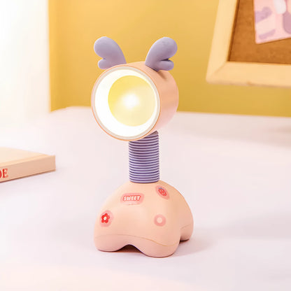 Colourful cartoon character magnetic DIY night light on a desk with adjustable head.