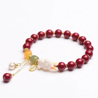 Traditional Chinese cinnabar bracelet with bunny design in purple-gold sand colour