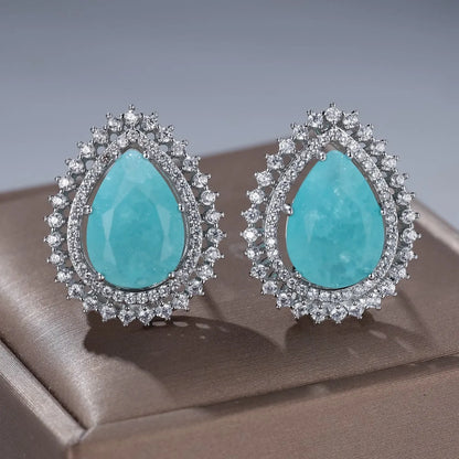 A pair of women's heart-shaped earrings with a platinum ice flower diamond colour finish.