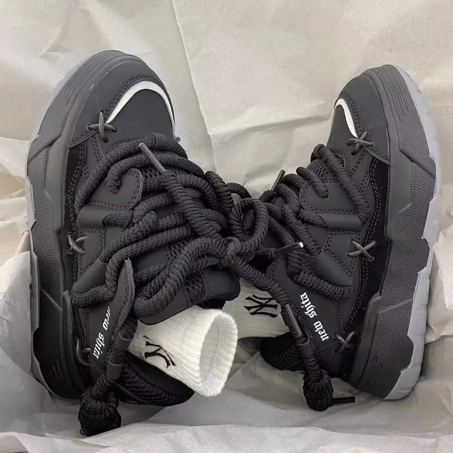 Women's grey retro chunky sneakers with thick flat rubber platform sole and lace-up front.