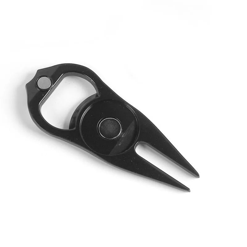 Black zinc alloy golf ball fork and bottle opener tool on a putting green.