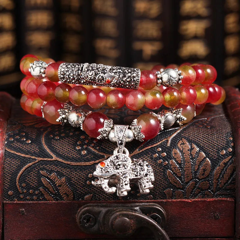 Handmade bracelet with green and pink watermelon crystal beads tied with Chinese knots.
