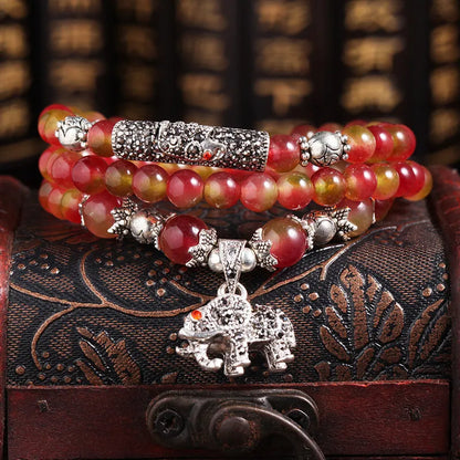 Handmade bracelet with green and pink watermelon crystal beads tied with Chinese knots.