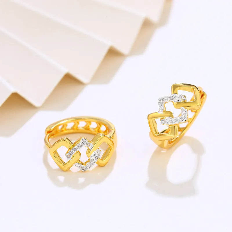 Pair of gold-coloured geometric alloy stud earrings with a hollow-out design on a plain background.