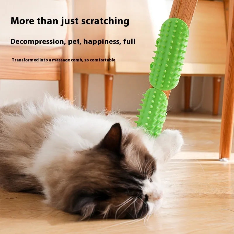 Silicone cat grooming comb with adjustable strap mounted on a table leg, shown in green.