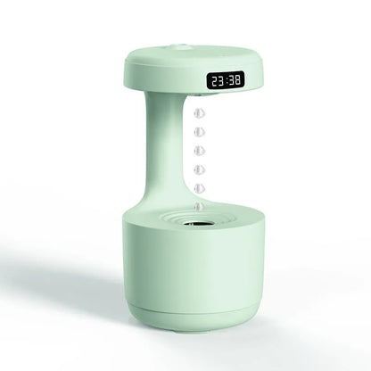 White anti-gravity humidifier showing water droplets appearing to levitate upwards from its base