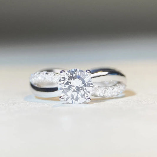 Geometric silver ring with winding twisted arm and 1 karat moissanite stone in four-claw setting