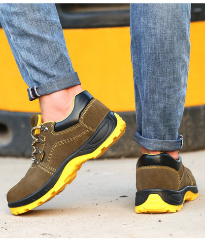 Bronze cow suede low-cut safety shoes with steel toe cap and patterned rubber sole on a workbench.