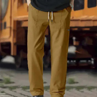 Men's light grey polyester trousers with an elasticated waistband laid flat