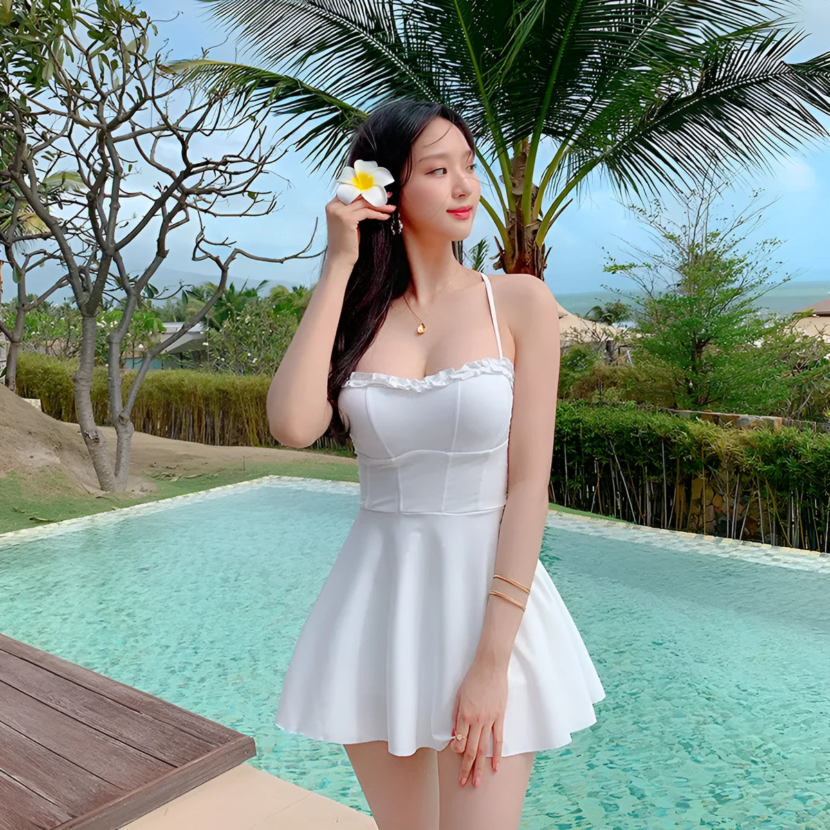 White women's one-piece swimsuit with hollow out design and skirt