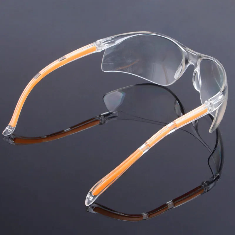 Transparent polycarbonate safety goggles with yellow frame for lab and welding protection.